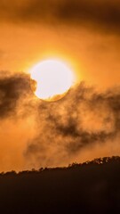 Wall Mural - Timelapse of dramatic sunset with orange sky in a cloudy day.