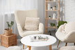 © Pixel-Shot - Table and white soft armchairs in interior of living room, closeup