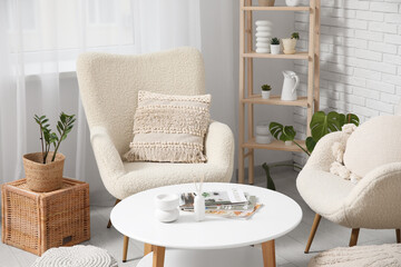 Wall Mural - Table and white soft armchairs in interior of living room, closeup