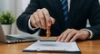 © Adeva - Business Man Stamping Legal Document
