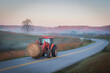 © Cavan Images - Rural Kentucky Autumn Morning: Tractor Transporting Hay Bale on