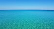 © Kapten - Tranquil turquoise ocean waters under a bright blue sky horizon