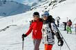 © K-FK - Two young adult happy friends candid portrait enjoy have fun skiing enjoy winter extreme sport activities on sunny day. People winter sport active holidays. Healthy people lifestyle