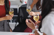 © crizzystudio - Women colleagues celebrating office party drinking white wine