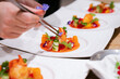 © Kajornsiri - Chef Plating Fine Dining Dish with Edible Flowers and Lobster