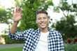 © New Africa - Happy young man waving goodbye in park