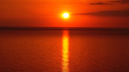 Wall Mural - Fiery Sunset Over Still Waters