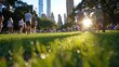 © Milos - Visitors stroll leisurely through a lush green urban park, highlighted by the stunning city skyline in the background and warm sunlight filtering through the trees.