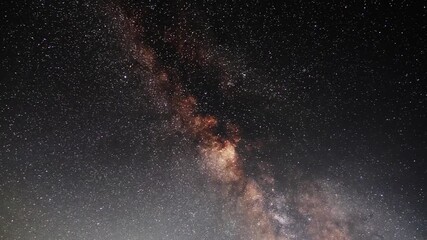 Wall Mural -  Starry sky timelapse background. Beautiful night sky with Milky Way galaxy on dark sky.