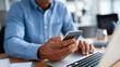 © Kateryna - Office worker using smartphone at organized desk with laptop open for business communication and digital workflow management in contemporary workplace office desk work smartphone