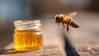 © Firda - Honeybee hovering near a small honey jar