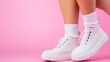 © savittree - Stylish female legs in modern shoes against pastel pink backdrop