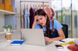 © snowing12 - Asian adult woman online clothing business owner managing orders home office desk facing entrepreneurship stress digital marketing challenges retail sales
