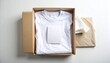 © Faiz - Minimalist white t-shirt neatly folded inside a cardboard box with blank label, suitable for clothing packaging, branding mockup, online fashion store, and product presentation concept.