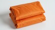 © ThanhLuan - 선명한 오렌지색 천이 깔끔하게 접혀 밝은 배경 위에 놓여있는 정물 사진