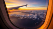 © WARDA - Stunning aerial view of sunset over ocean and clouds seen through airplane window