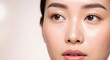 © Katsyarina - Woman's face with clean, healthy skin. Closeup of beautiful Asian girl with natural makeup looking right. Beauty, cosmetic, skincare concept.