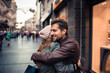 © Davor - Couple embracing in city street