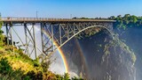 Victoria Falls Bridge with Rainbow and Waterfall.