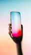© ADDICTIVE STOCK - Hand holding a mobile phone displaying a colorful screen