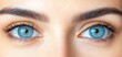 © imagineRbc - Close-up captures a woman's stunning, symmetrical face, showcasing her bright blue eyes and perfectly shaped eyebrows and eyelashes