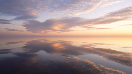 Wall Mural - Abstract patterns of a cloudy sky subtly reflected on a still, undisturbed water surface at dawn still undisturbed water, atmospheric, artistic