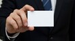 © FAWF STUDIO - A male hand in the foreground holding a blank white business card, with a dark suit blurred in the background.