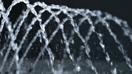 Wall Mural - A slow dolly shot reveals a spectacular slow motion water fountain, with countless droplets sparkling under studio illumination motion, exciting, power