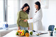 © Home-stock - Professional woman dietologist finding out waist length of mature female patient with measuring tape in consulting room in clinic