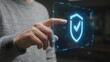 © 晨 晨 - Person interacting with a futuristic holographic security interface displaying a shield icon