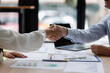 © David - Business people, negotiation and handshake for deal, agreement or partnership in office. Shaking hands and hiring offer for recruitment, b2b collaboration or data analyst at table in meeting