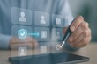 © Haseeb - Person using stylus with holographic security shield and user profile icons on tablet symbolizing identity protection and authentication