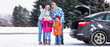 © Pixel-Shot - Parents with their little children and car on snowy winter day