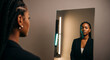 © Ace - A powerful portrait of a Black businesswoman looking at her reflection in a mirror, a perfect concept for self-reflection, confidence, and identity