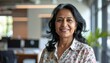 © Hyejin Kang - Indian smiling happy middle aged business woman look at camera do pose for head shot portrait at workplace.