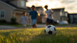 © Curioso.Photography - Children playing soccer on grass field in suburban neighborhood at sunset.