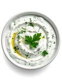 Creamy white dip in bowl, garnished with herbs