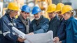 © CStock - Construction workers examining blueprints on a building site, showcasing teamwork and industry expertise.