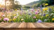 © Tasnim - Rustic wooden planks providing a foreground stage for product display against a colorful summer wildflower meadow background