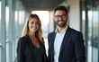 © liang - Portrait of two business people smiling in modern office hallway. High quality