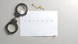 © Kegelapan - Handcuffs placed on paper with word freedom beside judge’s gavel.