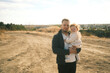 © Kantemir Production - A father holds his baby on a scenic pathway, enjoying the outdoors and creating memories