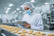 © Vlad - Food Health Inspector: Checking Cookie Quality on Factory Conveyor with Tablet