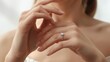 © Ant - A close-up of a woman's hands elegantly displaying a sparkling ring, symbolizing love and commitment.