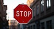 © Dece Std - Red stop sign with blurred buildings in the background on overcast day
