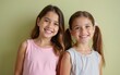 © Jordan - Portrait of two cheerful young girls standing together and looking at the camera. High quality