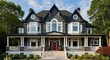 © Devi - Elegant and inviting multi-story home features a dark gray exterior, white trim, a welcoming porch, and a vibrant red front door, creating a picturesque and sophisticated residential facade under a...