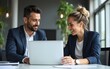 © Donna - Two happy professional business man and woman executive leaders team using laptop working on computer at work desk having conversation on financial project at meeting in office. High quality