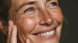 © Selvam - happy smiling pretty shy 50s middle aged woman laughing cheerful mature lady touching healthy soft face skin anti age healthy skincare treatment and cosmetic ads face close up view portrait no logos