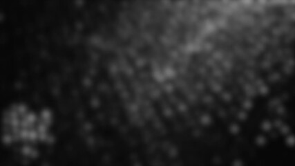 Blurred macro shot of grey plastic woven mesh with soft highlights and diffused textured pattern.